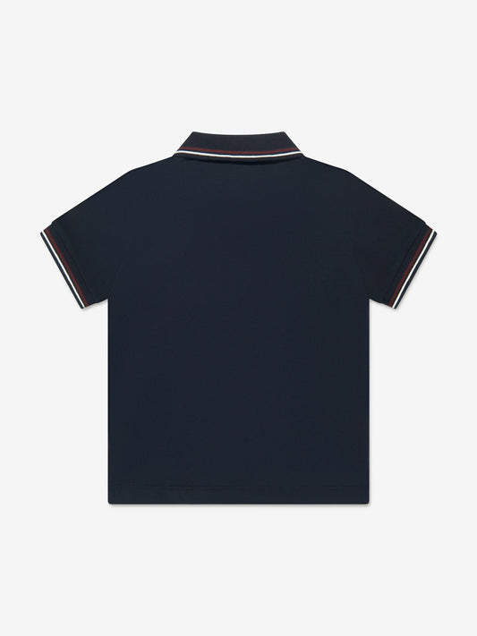 Navy blue polo shirt with white trim on a light gray background