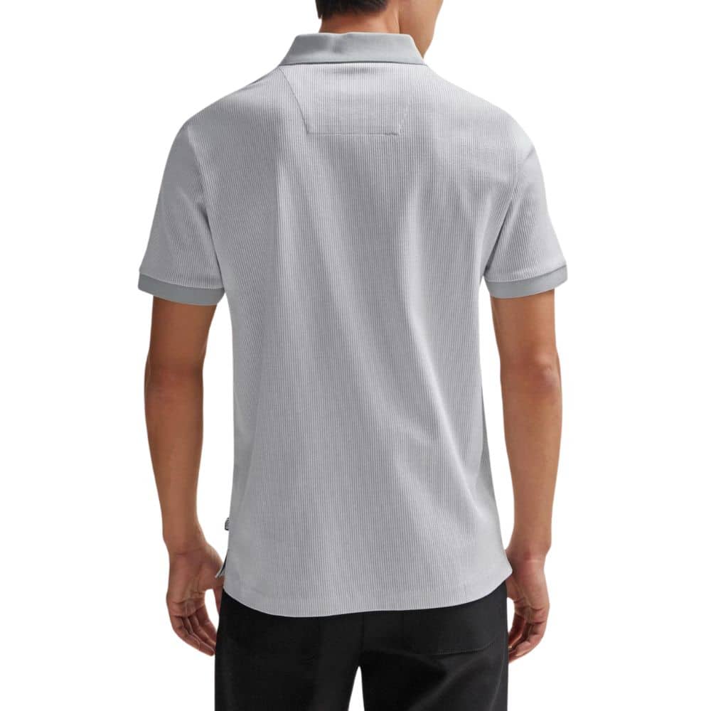 Back view of a person wearing a gray polo shirt on a white background