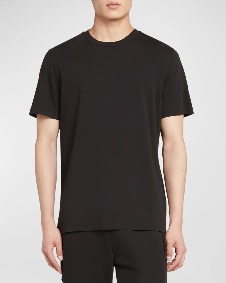 Person wearing a black t-shirt and pants on a white background