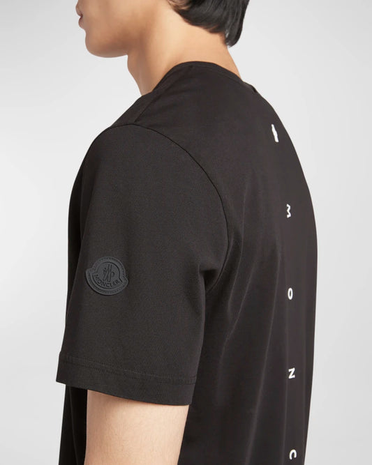 Black t-shirt with brand logo and text on a white background