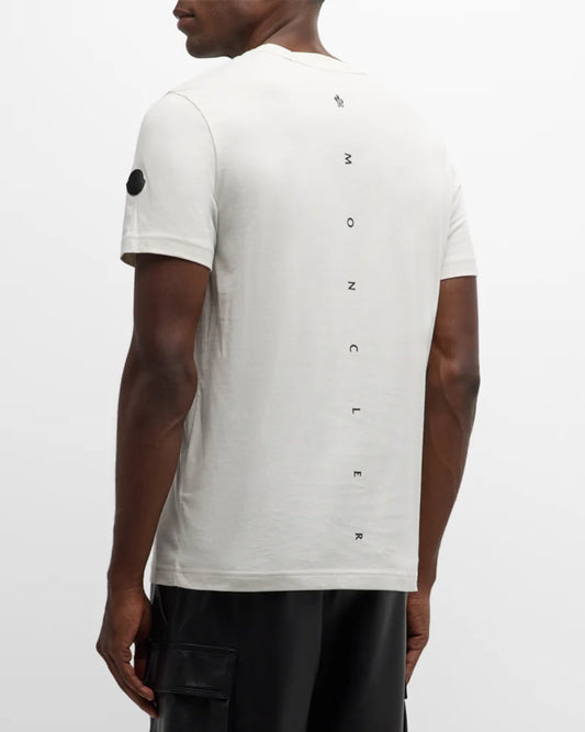 Person wearing a white t-shirt with black text on the back against a white background