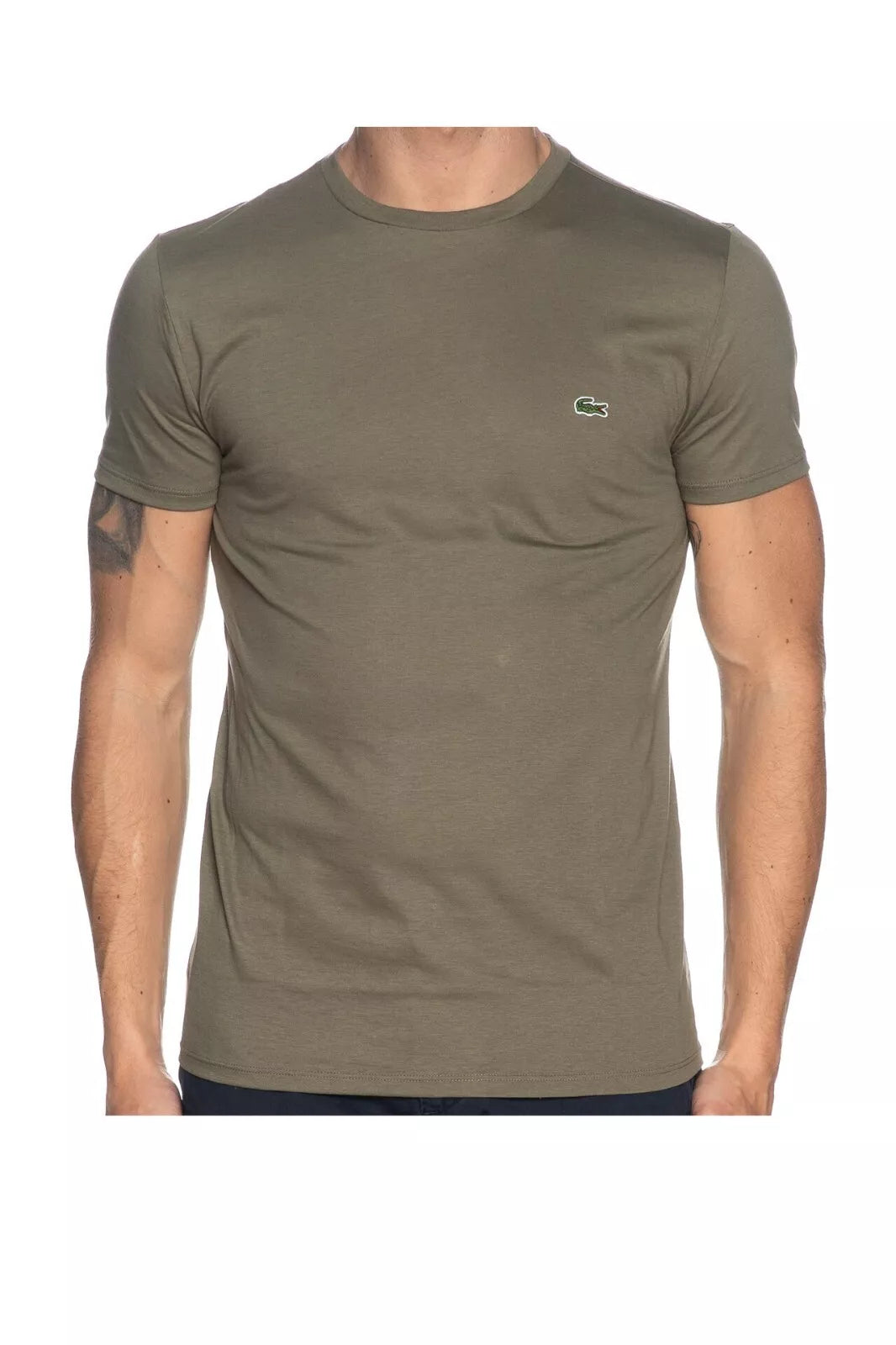 Man wearing a green t-shirt with a logo on a white background