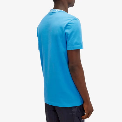 Person wearing a blue polo shirt on a white background