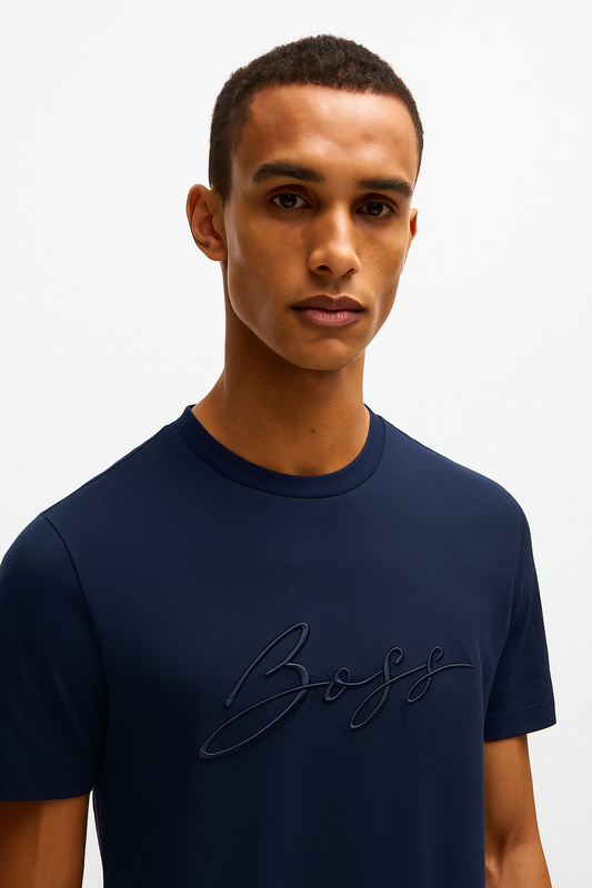 Man wearing a navy blue t-shirt with 'BOSS' logo on a white background
