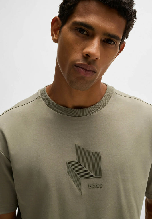 Man wearing a light green t-shirt with a geometric design and 'BOSS' logo.
