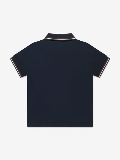 Navy blue polo shirt with white trim on a light gray background