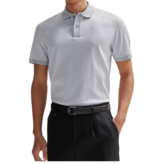 Person wearing a gray polo shirt and black pants on a white background