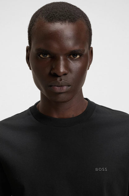 Man wearing a black shirt with 'BOSS' logo on a white background