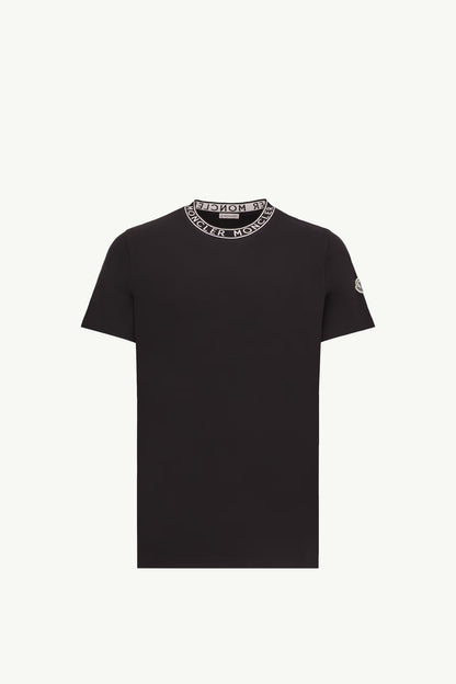 Black t-shirt with a brand logo on the collar against a white background
