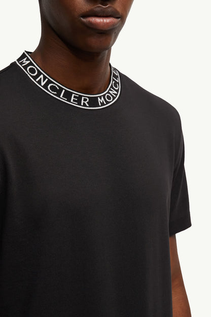 Black t-shirt with Moncler logo on collar against a white background