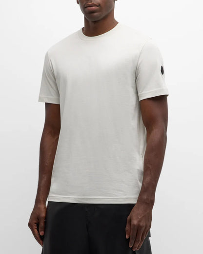 Person wearing a plain white t-shirt against a white background